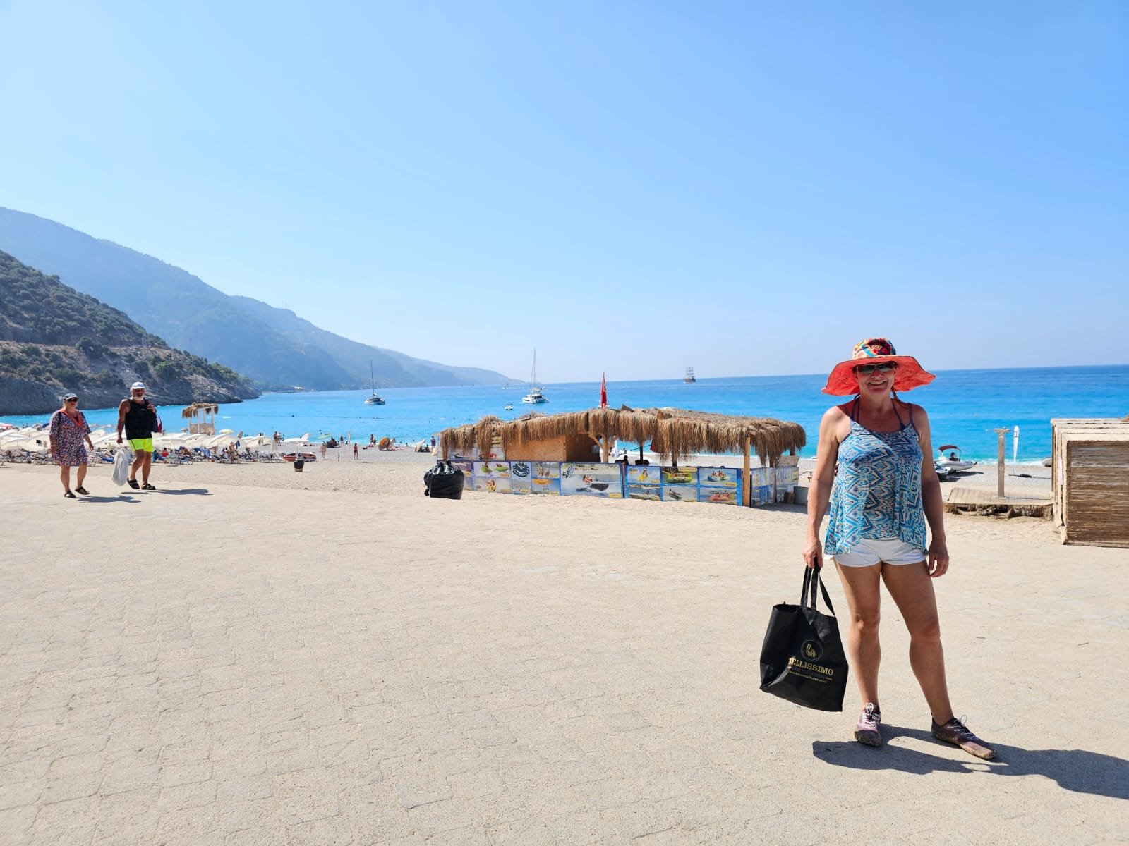 Roshell on the beach at Ölüdeniz, Turkey, with the turquoise sea behind her