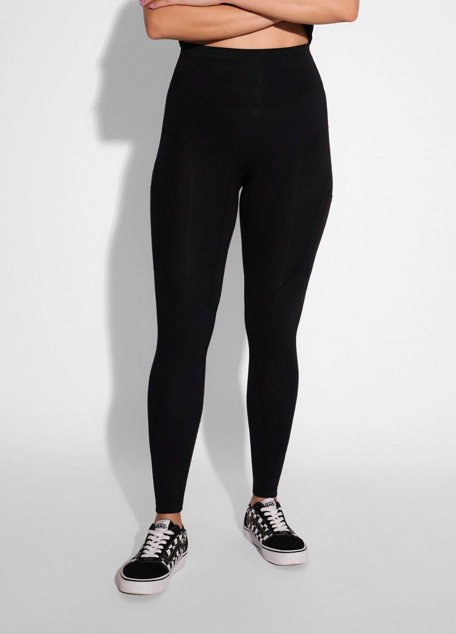 Breeth Regular Cotton Leggings in black, full length, worn with a cropped top and canvas sneakers.